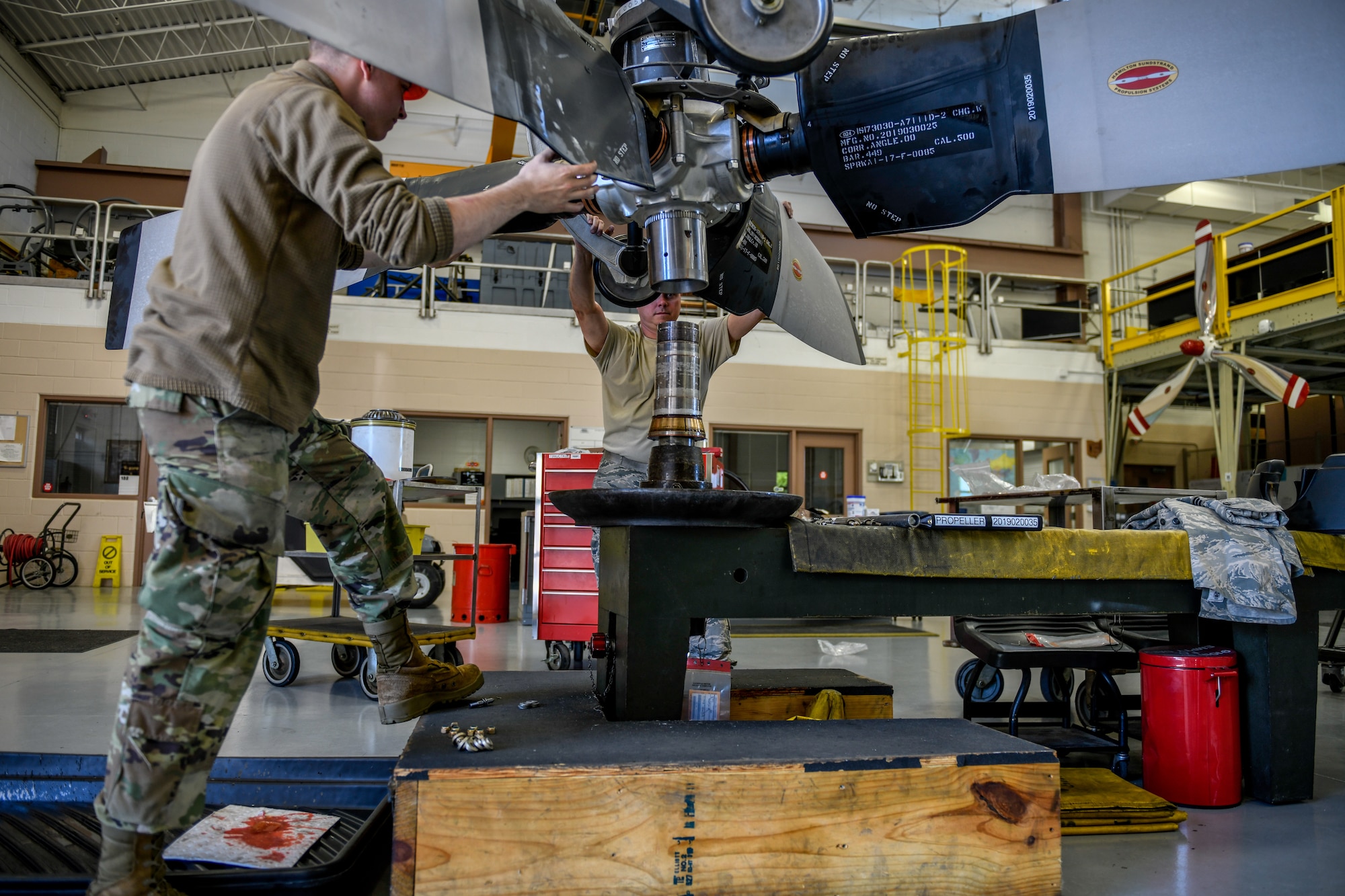 Senior Airman Sean Kenney, an aerospace propulsion apprentice with the 910th Aircraft Maintenance Squadron, and Tech. Sgt. Steven Lew, an aerospace propulsion craftsman with the 910 AMXS, prepare a propeller for installation on a C-130H Hercules aircraft June 11, 2019, here.