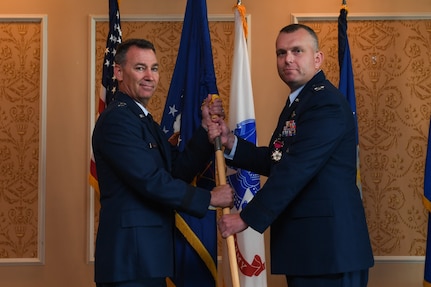 U.S. Air Force Maj. Gen. Chad Franks, left, Ninth Air Force commander, receives the guidon for the 633rd Air Base Wing from the outgoing commander, Col. Sean Tyler, during a change of command ceremony at Joint Base Langley-Eustis, Virginia, June 20, 2019.