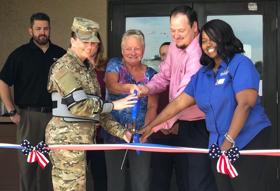 The first Micro Markets opened this week in Bldgs. 5929 and 5947. Micro Markets are mini-marts housed in the bottom of dormitories that are accessible 24/7. Consumers are able to make purchases with cash, card or credit through a key fob loyalty program. Partnering with the Army & Air Force Exchange Service and Imperial Vending, the Micro Markets are in place to compensate for the Dining Facility’s renovation closure. 72nd Air Base Wing Command Chief Master Sergeant Melissa Erb cuts the ribbon on the grand opening of the Bldg. 5929 Micro Market June 18 with Tinker Exchange Services Manager Angela Gray, Imperial Vending Distributor Jeremy Willhite and Exchange General Manager Vanessa Roland.