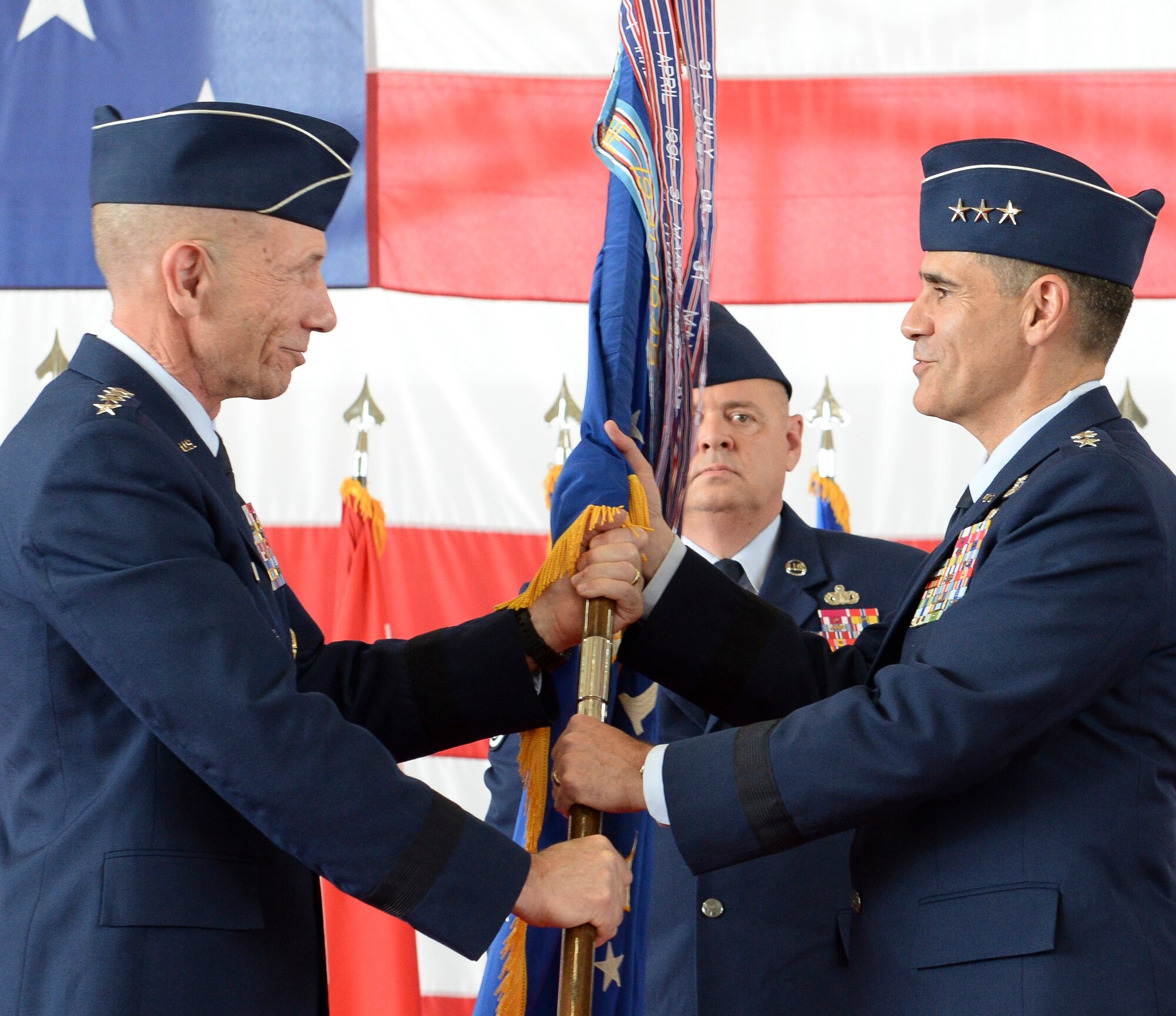 U.S. Air Force Lt. Gen. Marc Sasseville, commander, 1 AF (Air Forces Northern) and Continental U.S. North American Aerospace Defense Command Region (CONR) accepts the 1 AF guidon from General James Holmes, commander, Air Combat Command, during a change of command ceremony June 20, 2019, Tyndall AFB, Fla.  Holmes, along with General Terrance O’Shaughnessy, commander, United States Northern Command and North American Aerospace Defense Command officiated the 1 AF, CONR (AFNORTH) Change of Command. (U.S. Air National Guard Photo by Master Sgt. Regina Young)