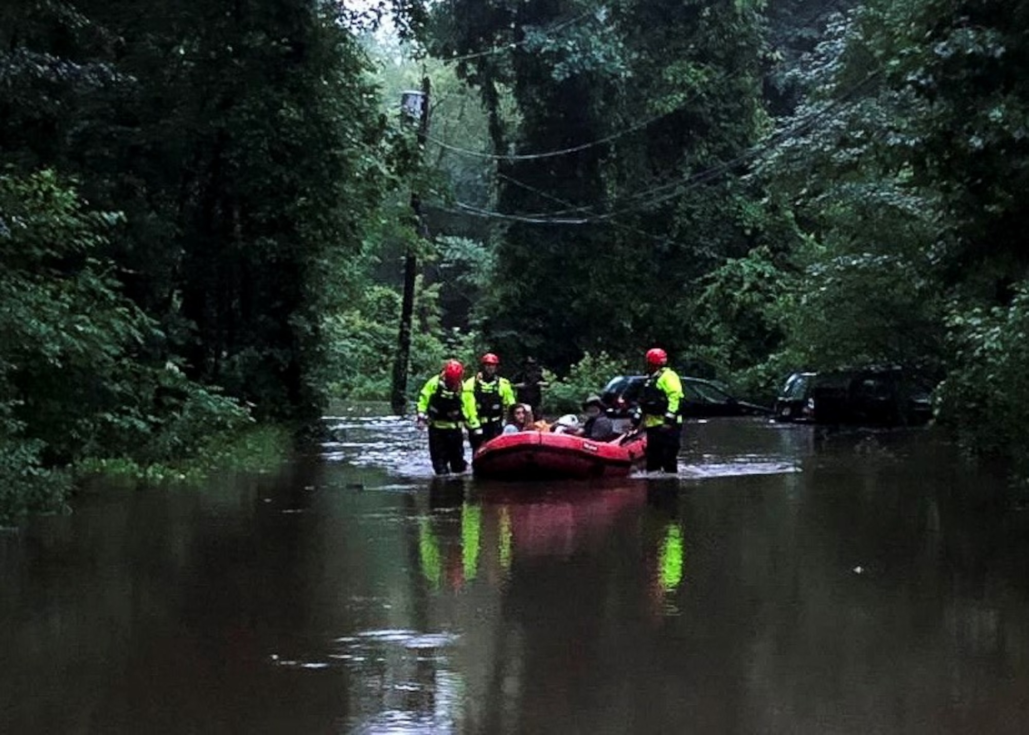 Firefighters from Joint Base McGuire-Dix-Lakehurst, New Jersey, rescue a family of four from flood waters after overnight storms caused water levels to rapidly rise in Mount Holly, New Jersey, June 20, 2019. Partnering with mutual aid fire companies from Pemberton and Eastampton during the rescue, the firefighters from Joint Base MDL are able to use these events to train and gain experience for future scenarios that may arise. (Courtesy photo)