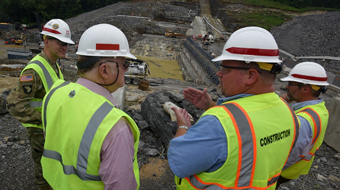 Bill DeBruyn (Second from right), Center Hill Dam Rehabilitation Project resident engineer, explains the status of ongoing construction of a roller compacted concrete berm next to the saddle dam to William S. Crowder (Second from left), Army Science Board study chair, during a visit June 18, 2019 to the project in Silver Point, Tenn.  Lt. Col. Cullen Jones, U.S. Army Corps of Engineers Nashville District commander, and Ben Rohrbach, Nashville District Engineering and Construction Division chief, also provided project input. (USACE photo by Lee Roberts)