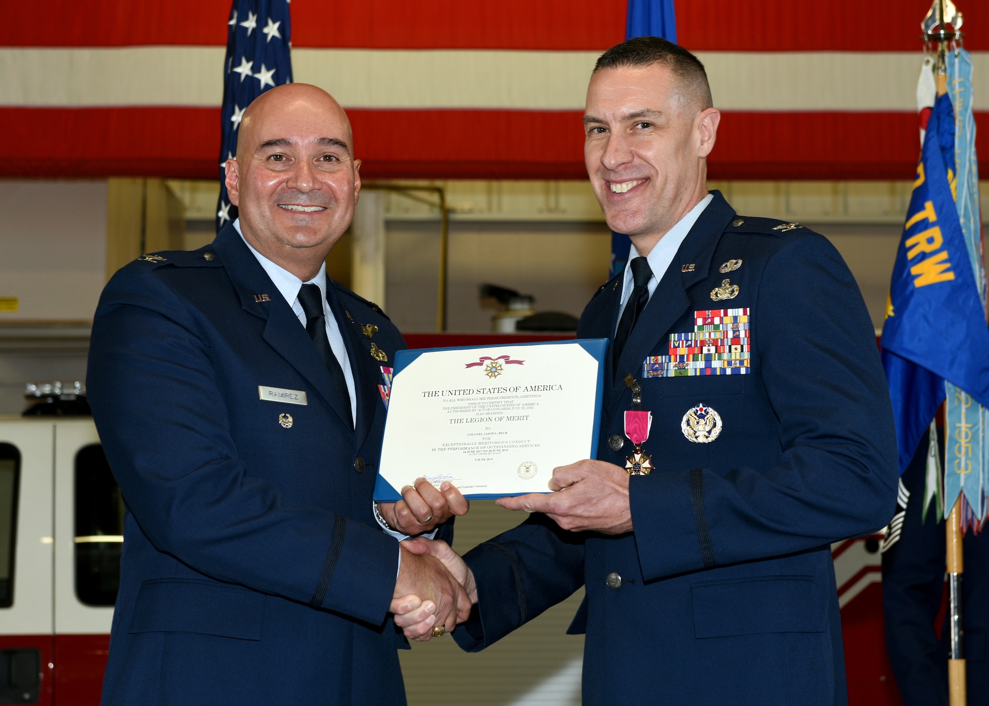 U.S. Air Force Col. Robert Ramirez, 17th Training Wing vice commander, presents Col. Jason Beck, 17th Mission Support Group outgoing commander, the Air Force Legion of Merit Medal during the change of command ceremony at the Transportation Complex on Goodfellow Air Force Base, Texas, June 20, 2019. As the commander of the 17th MSG, Beck oversaw over 900 military and civilian personnel delivering security, communications, logistics, civil engineering, contracting, and community support programs for the base. (U.S. Air Force photo by Airman 1st Class Robyn Hunsinger/Released)