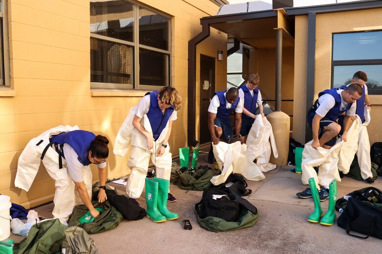 Airmen dawn protective gear to complete decontamination training