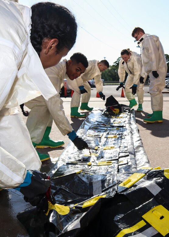 Airmen dawn protective gear to complete decontamination training