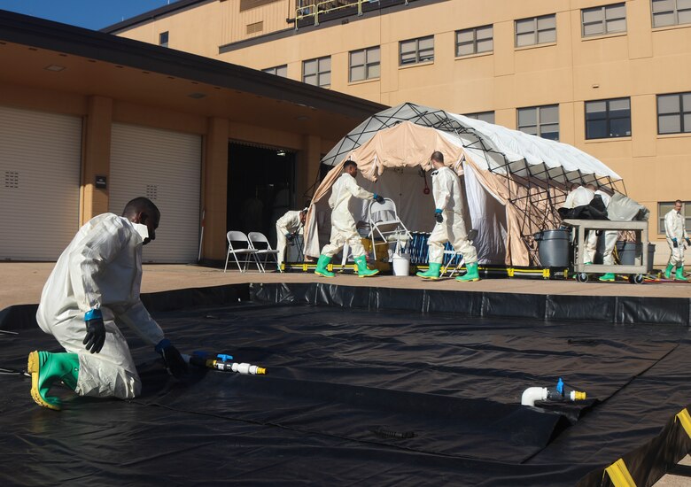 Airmen dawn protective gear to complete decontamination training