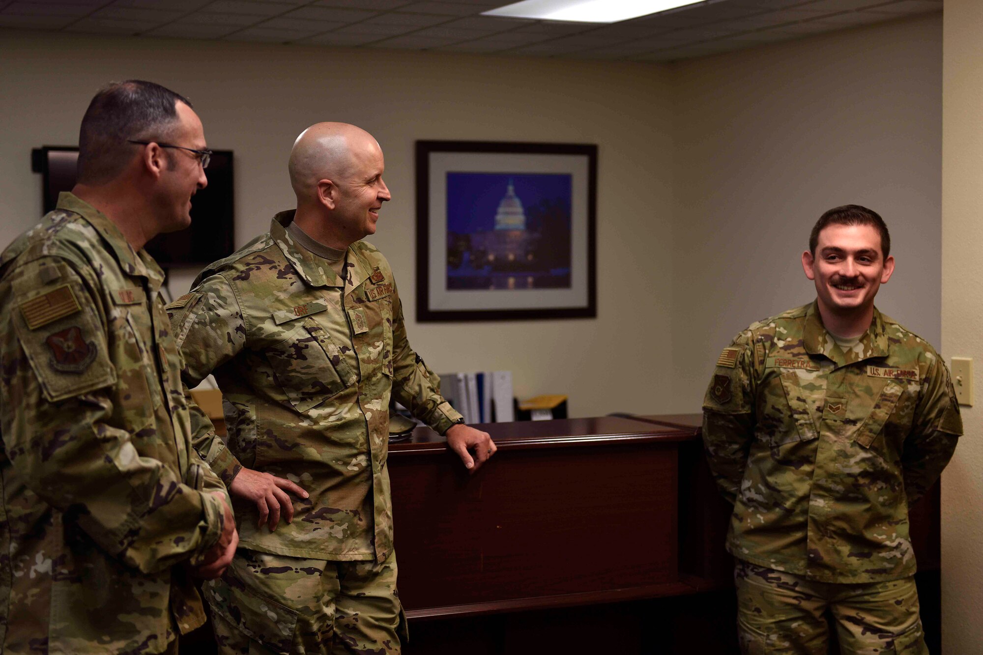 Chief Master Sgt. Charles Orf, 20th Air Force command chief (center) and Chief Master Sgt. William Cullins, 20th Air Force individual mobilization augmentee to the command chief (left) converse with Senior Airman Dagoberto Ferreyra, 377th Judge Advocate general law paralegal June 20, 2019 at Kirtland Air Force Base, N.M. Orf visited Airmen working in the 377th Air Base Wing during his visit to familiarize himself with his Airmen. (U.S. Air Force photo by Airman 1st Class Austin J. Prisbrey)