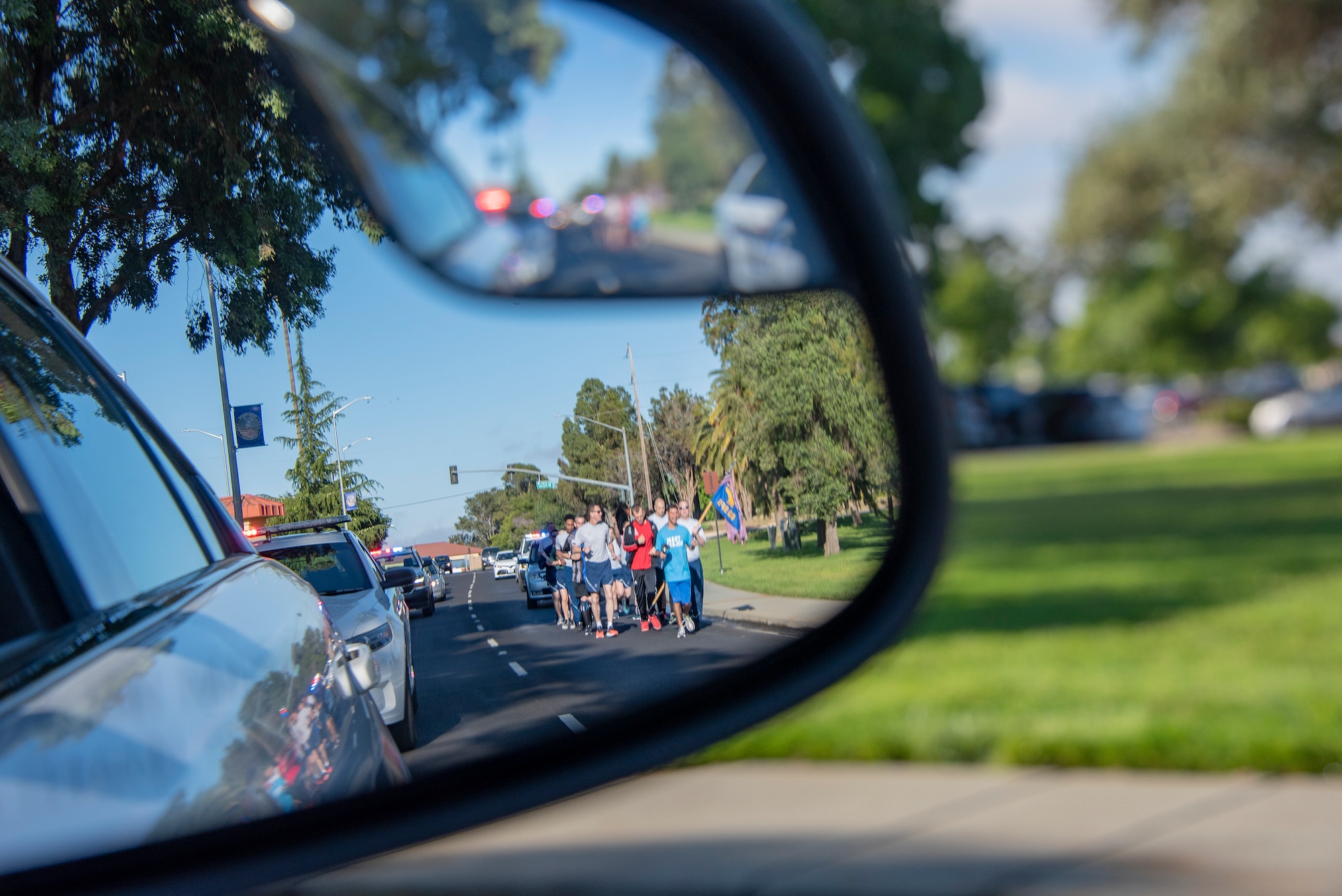 U.S. Air Force patrol vehicles escort 60th Security Forces Squadron defenders and athletes from Solano County during the Northern California Law Enforcement Torch Run June 20, 2019, at Travis Air Force Base, California. Hundreds of Law Enforcement personnel from northern California escorted the Special Olympics torch, the Flame of Hope, throughout their local communities in a relay to the 2019 Special Olympics Northern California Summer Games, being held at the University of California Davis campus June 21-23. (U.S. Air Force photo by Heide Couch)