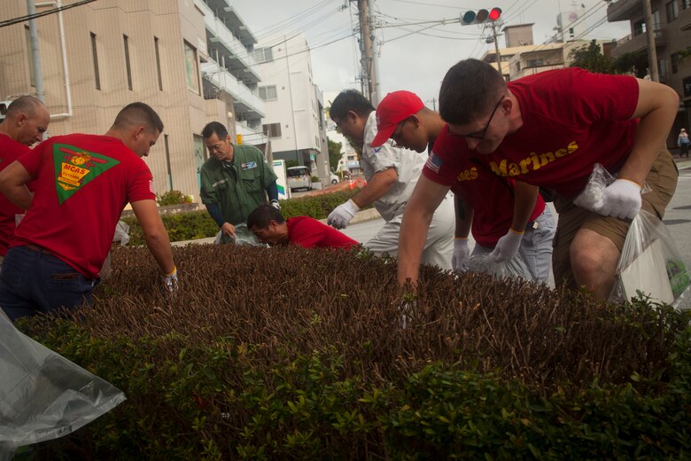 U.S. Marines and Okinawa residents volunteer their time to pick up garbage around the Ginowa convention area, Okinawa, Japan, June 19, 2019.