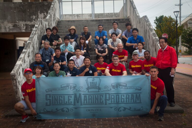 U.S. Marines and Okinawa residents pose for a group photo after the cleanup around the Ginowa convention area, Okinawa, Japan, June 19, 2019.