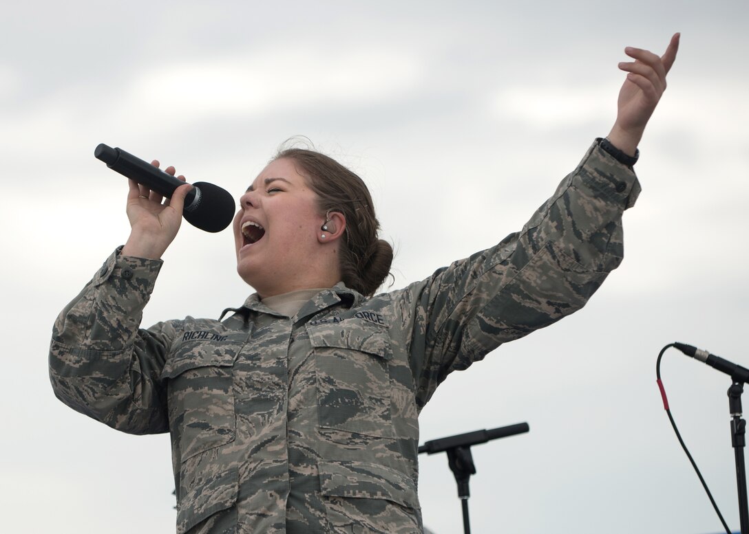 Airman 1st Class Aliyah Richling, assigned to the 55th Wing Band, sings on June 16, 2019, on Whiteman Air Force Base, Missouri. Richling and the other members of the U.S. Air Force Heartland Band performed at the 2019 Wings Over Whiteman Air and Space Show. (U.S. Air Force photo by Staff Sgt. Danielle Quilla)