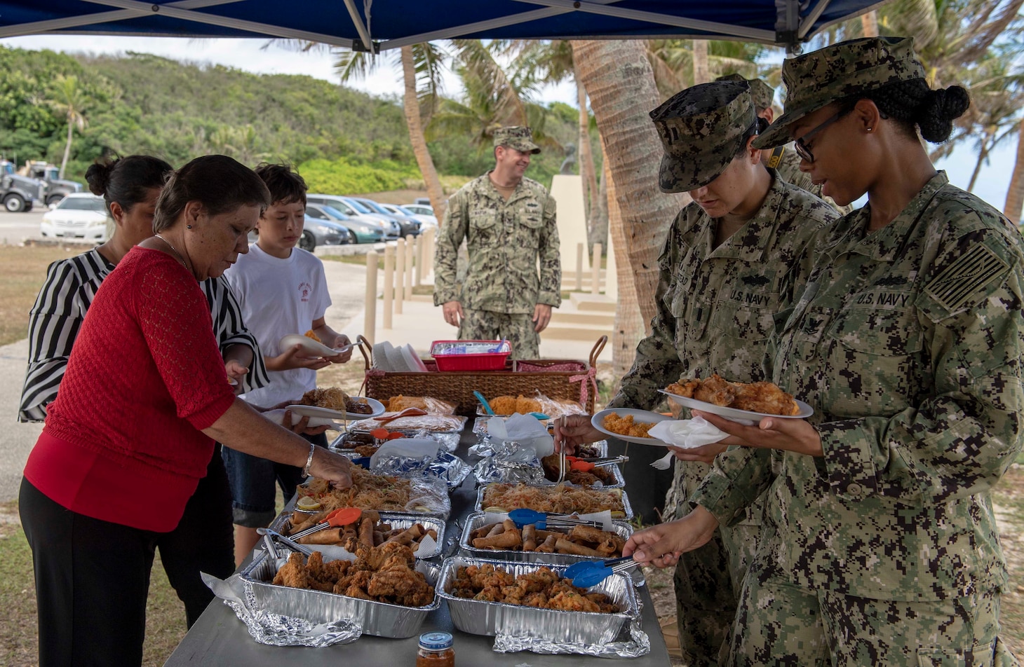 ASAN, Guam (June 20, 2019) Members of Seabee Betty’s family and Seabees assigned to Naval Mobile Construction Battalion 133, prepare to eat together during the Seabee Betty Day memorial celebration. Seabee Betty died June 9, 2003 and was interred June 20, 2003. In 2004, the governor of Guam declared June 20 to be Seabee Betty Day to honor the more than 50 years of dedicated service to the Seabee community on Guam.