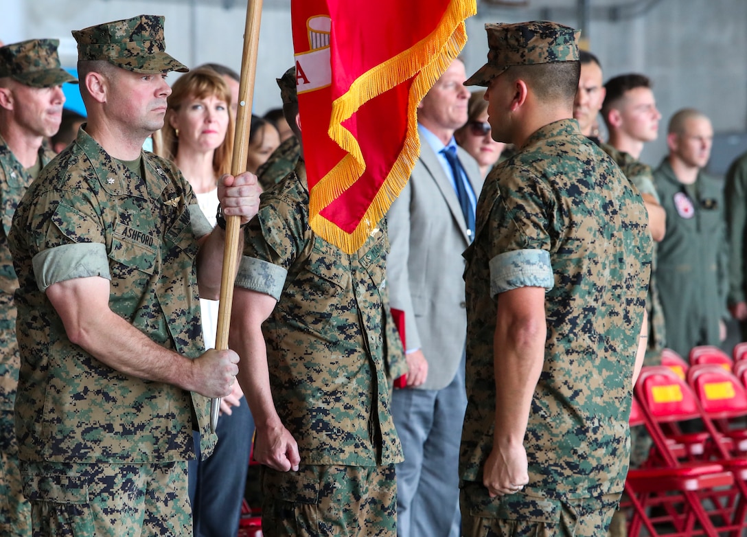 U.S. Marine Corps Lt. Col. Brian Ashford holds the Marine Corps flag during a change of command ceremony June 21, 2019 at Marine Corps Air Station Futenma.