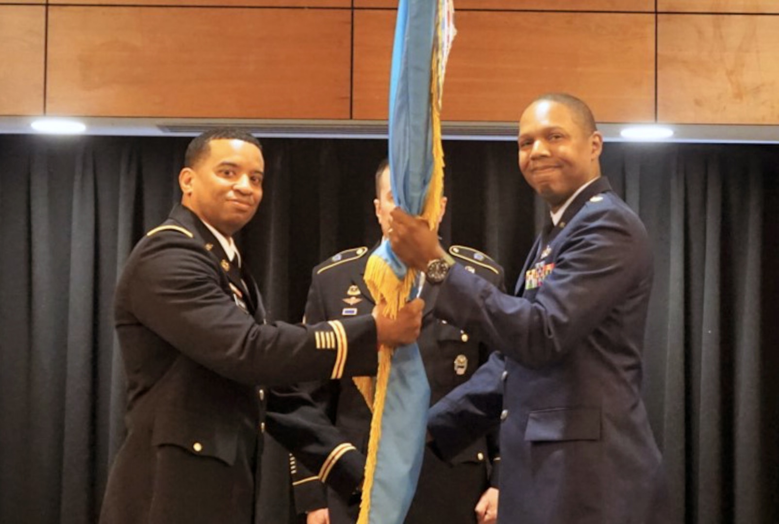 DLA Energy Americas Commander Army Col. Kevin Cotman presented the DLA flag to Air Force Maj. Marcus McWilliams
