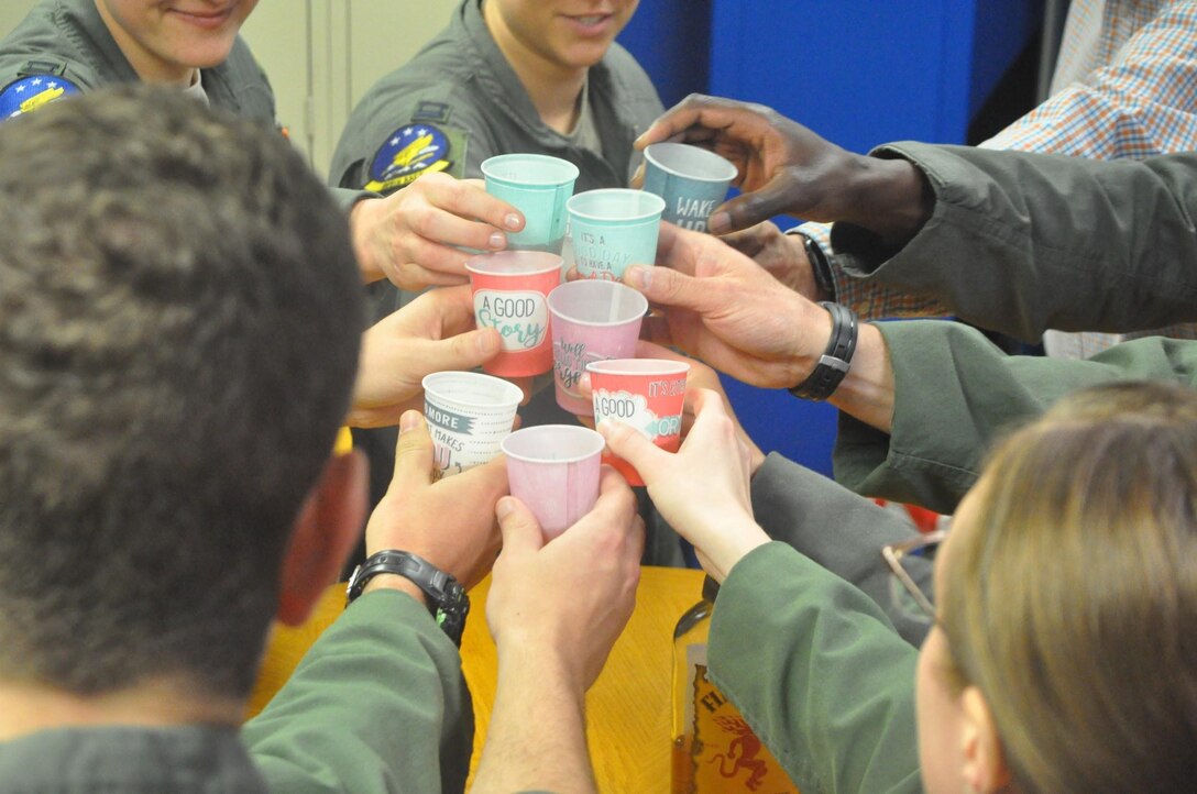 Members of the 965th Airborne Air Control Squadron toast to their passed squadron member Capt. Andrew K. Gordon after a memorial service held for him on June 6, 2019, Tinker Air Force Base, Oklahoma. (U.S. Air Force photo/Megan Prather)
