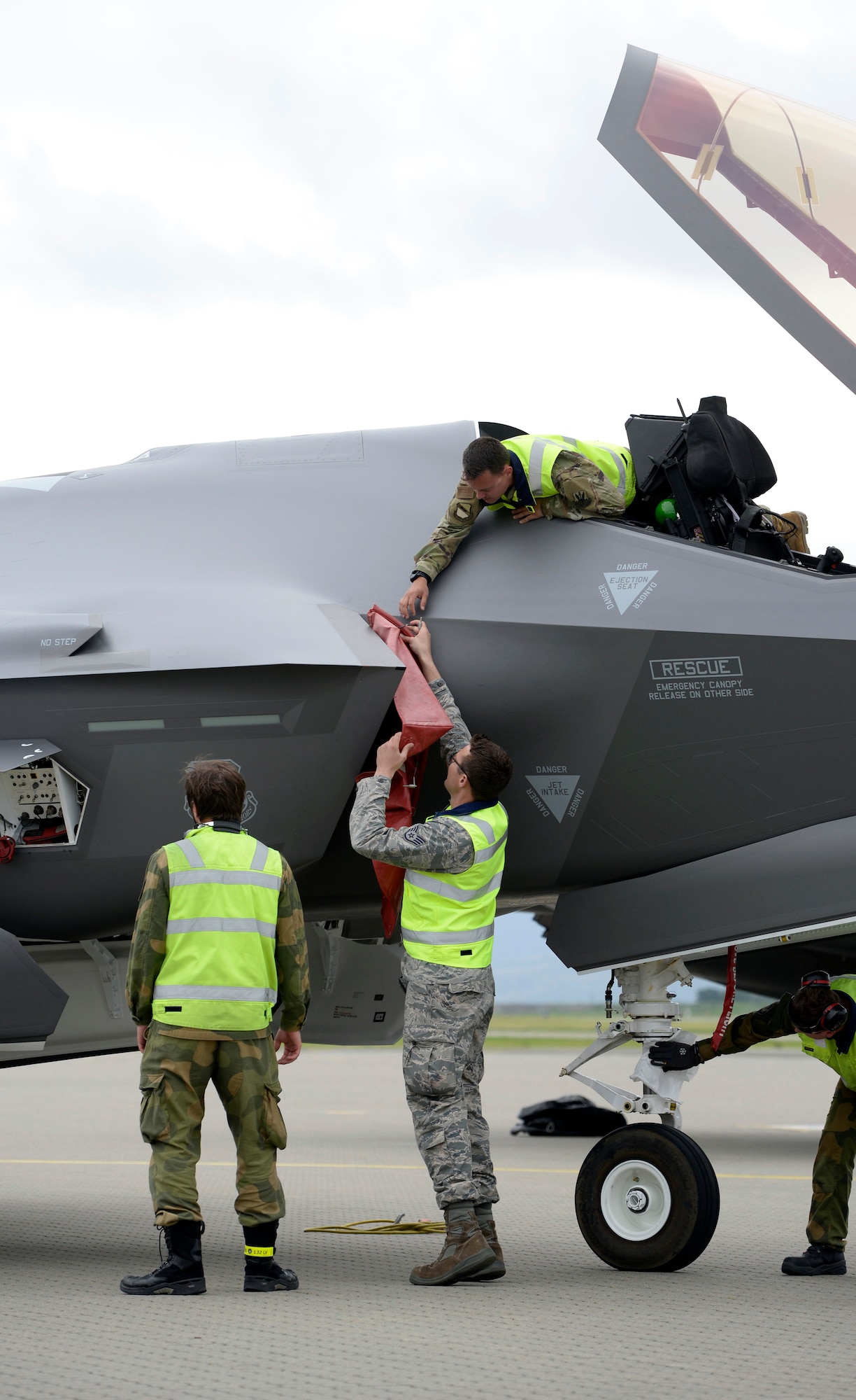 F-35 Lighting II maintainers from both the United States Air Force and Royal Norwegian Air Force work together at Orland Air Base, Norway, to turn two American jets after a sortie June 17, 2019. The visit marked the first time American F-35s have landed in Norway, which operates its own fleet of the fifth-generation fighters, and served as valuable training for the Norwegian maintainers. A fleet of F-35s is currently deployed to Europe as part of the European Deterrence Initiative, as as a way of proving the U.S. Air Force's ability to rapidly deploy fifth-generation fighters to European bases. (U.S. Air Force photo by Master Sgt. Austin M. May.)