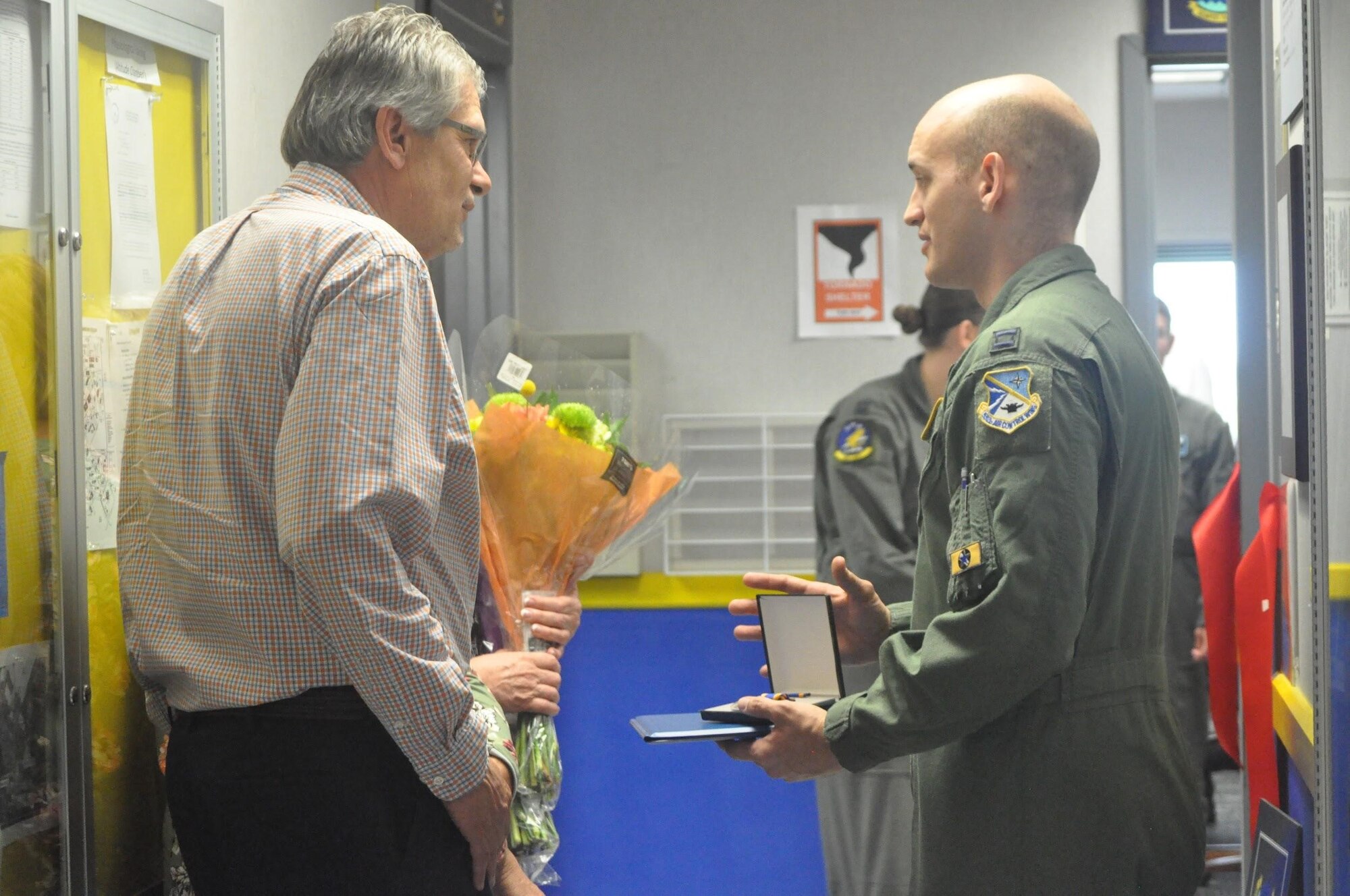 Capt. Kalan Clark, right, 965th Airborne Air Control Squadron, presented Gordon’s mother, Lisa Gilliam, and father, Bryan Gordon, with his Air Force Air Medal which hadn’t been approved yet before his passing following the dedication of a planning room in Gordon’s name June 6, 2019, Tinker Air Force Base, Oklahoma. (U.S. Air Force photo/Megan Prather)