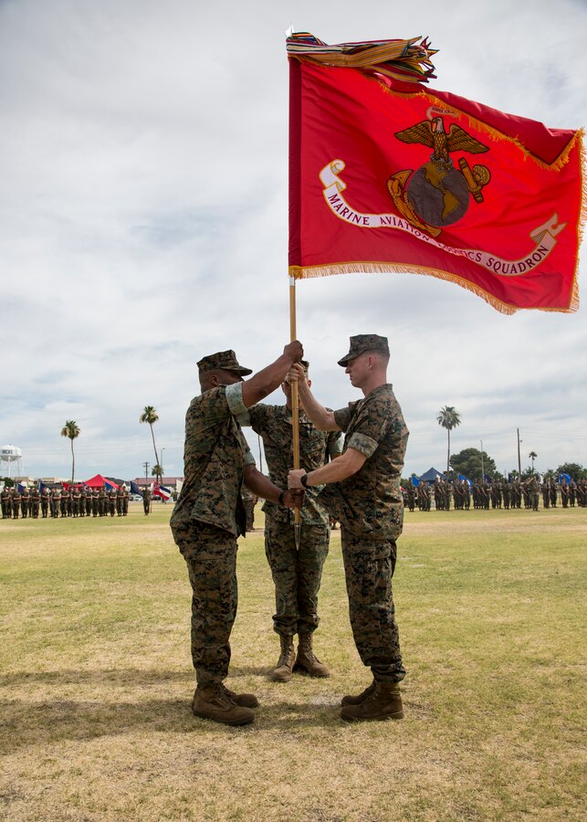 U.S. Marine Corps Lt. Col. Luke T. Watson, right, outgoing commanding officer of Marine Aviation Logistics Squadron (MALS) 13, Marine Aircraft (MAG) 13, 3rd Marine Aircraft Wing (MAW), passes the colors during MALS-13's change of command ceremony on Marine Corps Air Station Yuma, Ariz., June 13, 2019. During the ceremony, Lt. Col Luke T. Watson was recognized for his leadership, service and dedication to the Corps. The unit also welcomed Lt. Col. John Bacon Jr. as the new commanding officer. (U.S. Marine Corps photo by Cpl. Samuel Ruiz)