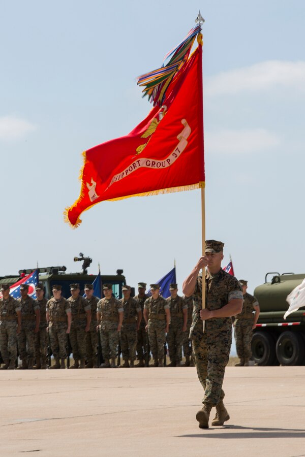U.S. Marine Corps Sgt. Maj. Paul Agan, sergeant major of Marine Wing Support Group (MWSG) 37, 3rd Marine Aircraft Wing, carries the unit colors during a change of command ceremony on Marine Corps Air Station Miramar, Calif., June 14, 2019. During the ceremony, Col. Matthew R. Seay was recognized for his leadership, service and dedication to the Corps. The unit also welcomed Col. Eric R. Quehl as the new commanding officer. (U.S. Marine Corps photo by Lance Cpl. Levi J. Guerra)