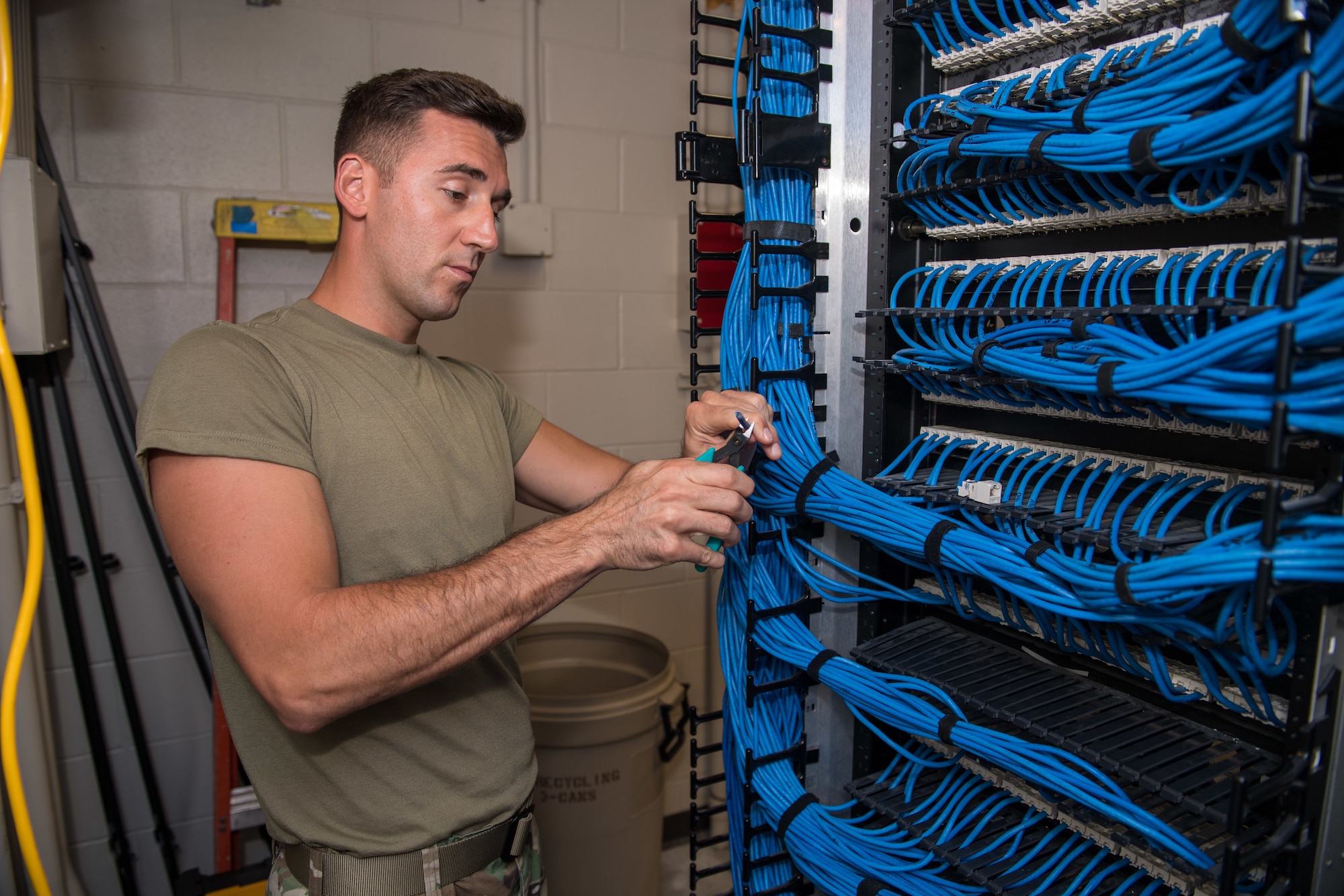 U.S. Air Force Tech. Sgt. Kenneth Overstreet, 178th Communications Squadron client systems from the Ohio Air National Guard, cuts a cable at Tyndall Air Force Base, Florida, June 18, 2019.