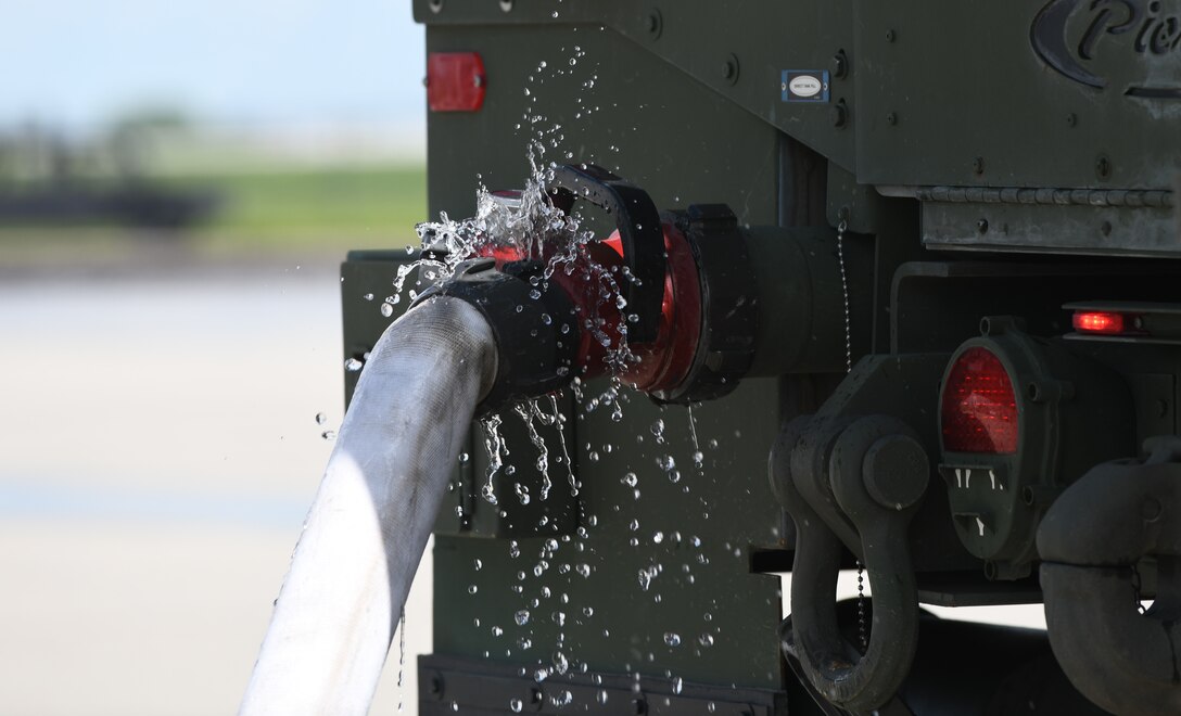 Firetrucks from South Dakota’s National Guard are filled with water prior to a modulation training exercise at the fire pit on Ellsworth Air Force Base, S.D., June 12, 2019. The firetrucks can hold approximately 1,000 gallons of water. During the course of two days, 8,000 to 10,000 gallons of water were used during the fire trainings. (U.S. Air Force photo by Airman 1st Class Christina Bennett)