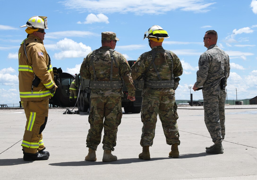 Ellsworth firefighters stand alongside firemen from South Dakota’s Army National Guard prior to a training exercise at the fire pit on Ellsworth Air Force Base, S.D., June 12, 2019. Ellsworth AFB has one of the last few jet-fueled fire trainers, making the training experience more realistic. (U.S. Air Force photo by Airman 1st Class Christina Bennett)