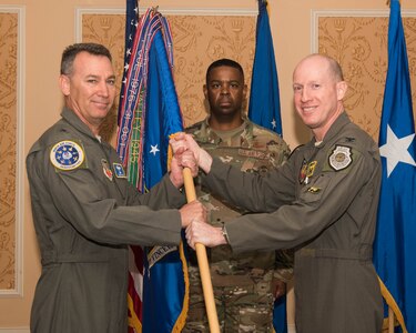 U.S. Air Force Maj. Gen. Chad P. Franks, left, Ninth Air Force commander, assumes the guidon for the 1st Fighter Wing from Col. Jason T. Hinds, during a change of command ceremony at Joint Base Langley-Eustis, Virginia, June 21, 2019. Hinds will be going to serve at the Pentagon, Washington D.C. (U.S. Air Force photo by Airman 1st Class Marcus M. Bullock)