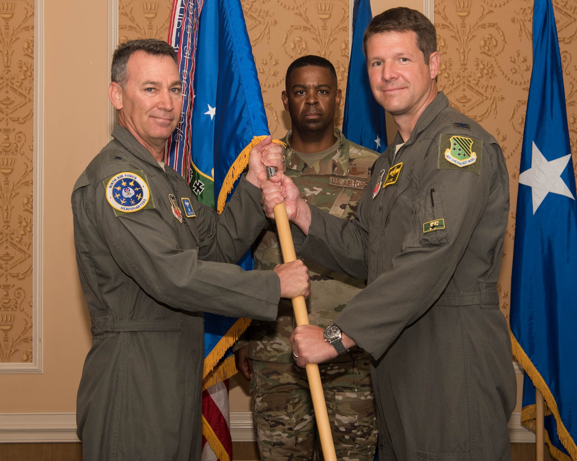 U.S. Air Force Maj. Gen. Chad P. Franks, left, Ninth Air Force commander, relinquishes the guidon for the 1st Fighter Wing to the incoming commander, Col. David R. Lopez, during a change of command ceremony at Joint Base Langley-Eustis, Virginia, June 21, 2019. Lopez previously worked as commander of the 1st Operations Group before taking command of the 1st FW. (U.S. Air Force photo by Airman 1st Class Marcus M. Bullock)