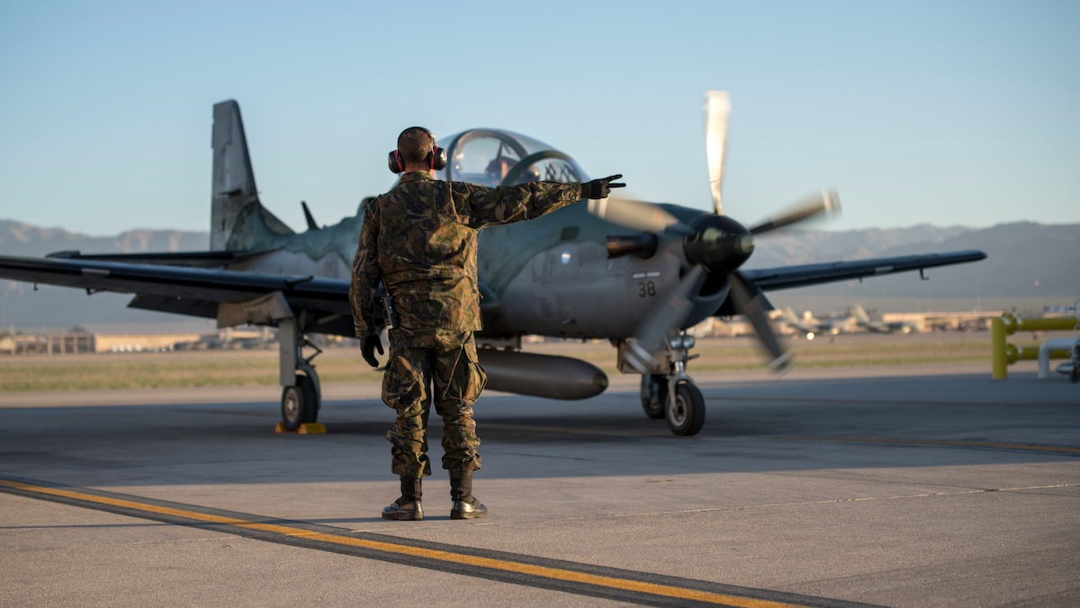 1st Sgt. DeBarros, a crew chief with the Brazilian Air Force, goes over pre-flight checks during Green Flag-West 19-8 at Nellis Air Force Base, Las Vegas, Nevada, June 8, 2019. The Brazilians and Idaho Air National Guard are supporting the 116th Cavalry Brigade Combat Team’s National Training Center rotation at Fort Irwin, California. (U.S. Air National Guard photo by Master Sgt. Joshua C. Allmaras)