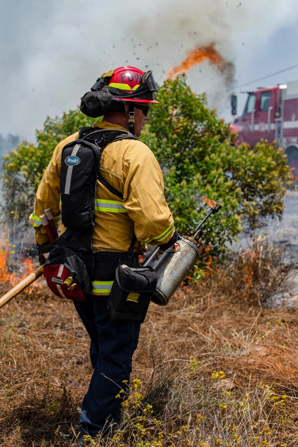 A firefighter starts fire during a controlled burn at Marine Corps Air Station Miramar, Calif., June 20. MCAS Miramar and local San Diego fire departments conducted this burn to reduce the risk of wild fires around MCAS Miramar and its community by working together on a controlled burn. (U.S. Marine Corps by Lance Cpl. Cheng Chang)