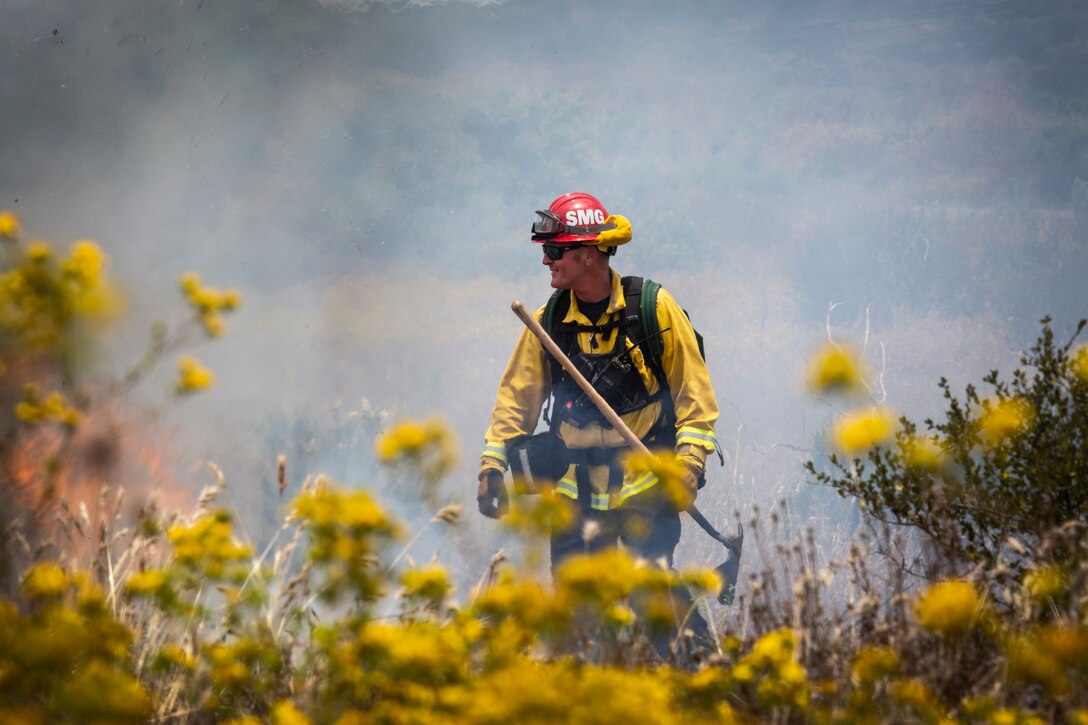 Firefighters from Marine Corps Air Station Miramar and local fire departments work together to conduct a series of controlled burns on East Miramar, Calif., June 20. The controlled burns were conducted to mitigate the chance of wild fires starting on MCAS Miramar as well as provide real world training to local firefighters. (U.S. Marine Corps photo by Sgt. Becky Cleveland)