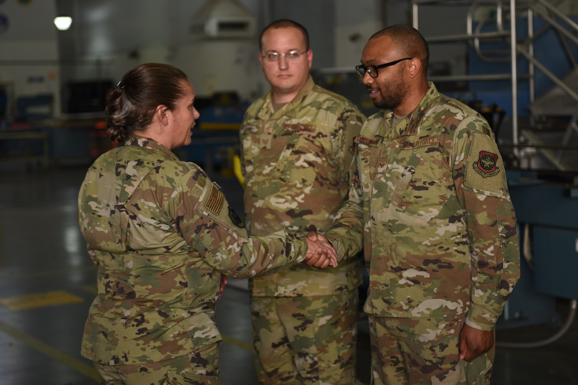 U.S. Air Force Brig. Gen. Linda Hurry, Defense Logistics Agency Aviation commander, left, recognizes Senior Airman Christopher Darrington, 60th Maintenance Squadron electrical and environmental systems journeyman, as a star performer June 17, 2019, at Travis Air Force Base, California. The general toured several units to learn firsthand about logistical operations and innovations at Travis. DLA Aviation is the combat logistics and supply chain manager for aviation and nuclear assets across the Department of Defense. (U.S. Air Force photo by Airman 1st Class Cameron Otte)