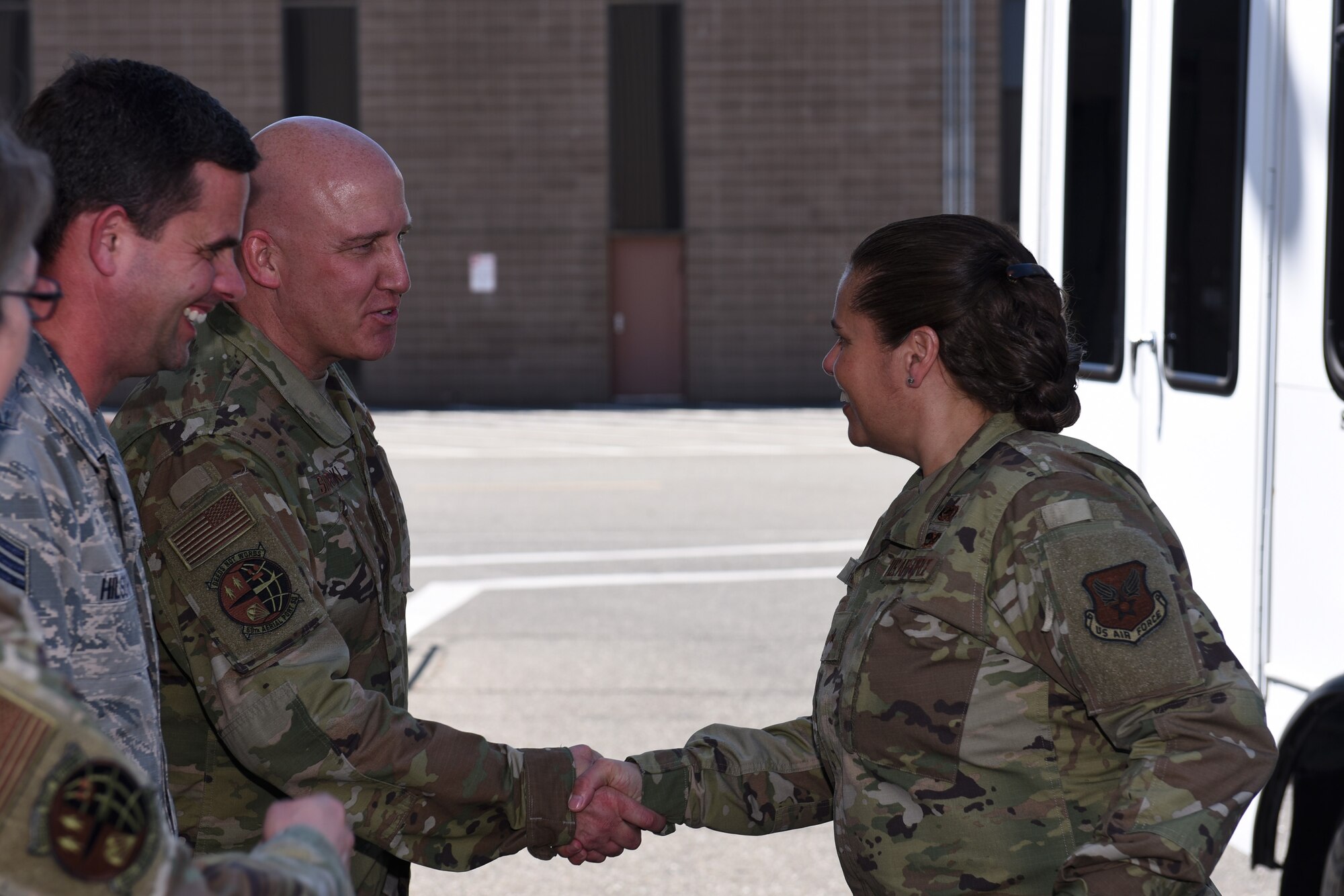 U.S. Air Force Brig. Gen. Linda Hurry, Defense Logistics Agency Aviation commander, is greeted by Chief Master Sgt. Brian Hilscher, 60th Aerial Port Squadron superintendent, and Chief Master Sgt. Scott Sikorski, 60th APS command chief, June 17, 2019, at Travis Air Force Base, California. The 60th APS showcased the mechanical material handling system and discussed how the system improve their ability to self-inventory and move pallets. DLA Aviation is the combat logistics and supply chain manager for aviation and nuclear assets across the Department of Defense. (U.S. Air Force photo by Airman 1st Class Cameron Otte)