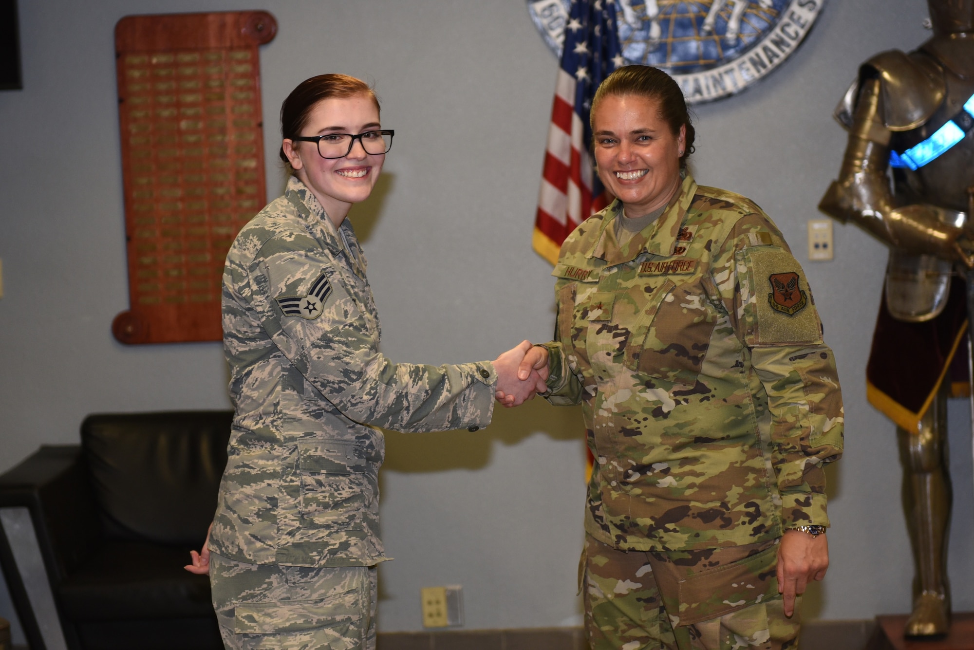 U.S. Air Force Brig. Gen. Linda Hurry, Defense Logistics Agency Aviation commander, right, recognizes Senior Airman Tracey Bass, 60th Aircraft Maintenance Squadron instrument and flight control systems journeyman, as a star performer June 17, 2019, at Travis Air Force Base, California. The general toured several units to learn firsthand about logistical operations and innovations at Travis. DLA Aviation is the combat logistics and supply chain manager for aviation and nuclear assets across the Department of Defense. (U.S. Air Force photo by Airman 1st Class Cameron Otte)