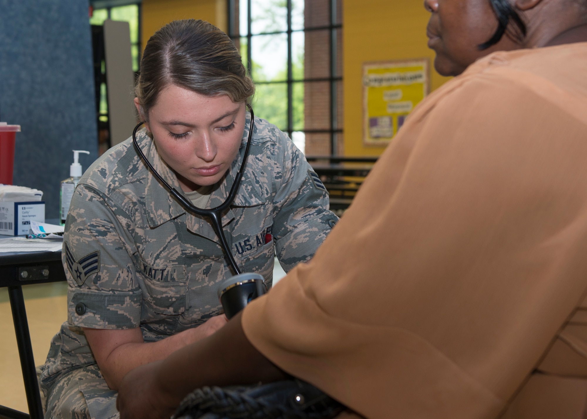 Senior Airman Kayla Katt, 103rd Airlift Wing aerospace medical technician, checks a patient’s blood pressure during East Central Georgia Innovative Readiness Training at Louisville Academy, Louisville, Ga. June 19, 2019. East Central Georgia IRT is a civilian-military collaboration intended to build on mutually beneficial parnterships between U.S. communities and the Department of Defense to meet the training and readiness requirements for Active, Guard, and Reserve Service Members and units while addressing community health needs. (U.S. Air National Guard Photo by Staff Sgt. Steven Tucker)