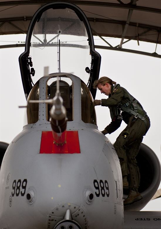 Lt. Col. Olivia Elliott climbs up into an A-10 at Edwards AFB, California in 2013. Elliott is an A-10 pilot and currently enrolled at the Air Force Institute of Technology as part of the Advanced Academic Degree program working on her PhD in hypersonic aerodynamics. (Courtesy photo)