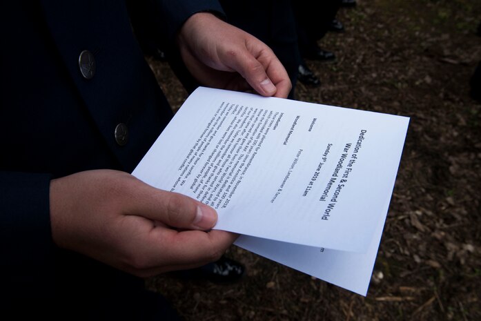 An Airman from Joint Base Charleston, S.C., reads an introduction during a Woodland Memorial Service, June 9, 2019, Ramsbury, U.K. The memorial service honored all those who gave their lives during the two World Wars and the servicemen currently serving in defense of our freedom. The ceremonial event was held to honor the sacrifices and strengthen the bond between the U.S. and U.K.