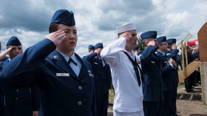 Senior Airman Summer Bell, 437th Maintenance munitions controller, salutes with service members from Joint Base Charleston, S.C., during the Royal Air Force Ramsbury Dedication ceremony, June 9, 2019, at Ramsbury Airfield, U.K. The ceremonial event was held to honor the sacrifices and strengthen the bond between the U.S. and U.K. The final stage of this Airfield Remembrance Project coincides with the 75th anniversary of D-Day.
