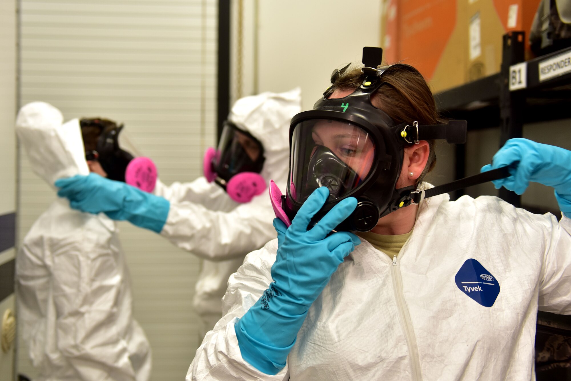A woman puts on a protective mask.