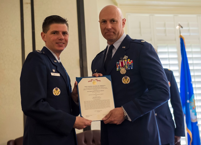 Col. Rockie Wilson, left, commander of the 628th Mission Support Group, presents the meritorious service medal to Lt. Col. William Parker, right, outgoing commander of the 628th FSS, during a change of command ceremony at the Charleston Club June 21, 2019, Joint Base Charleston, S.C. The 628th FSS is responsible for deploying services and personnel support teams, quality of life, professional and personal readiness, manpower and personnel services, food operations, lodging, fitness and leisure activities. Parker will be assuming a new role as the 628th MSG deputy commander.
