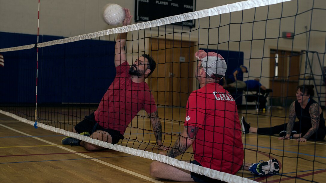 Canadian Armed Forces Warrant Officer Damien Pittman and Master Warrant Officer John O’Neill, wounded warrior athletes, practice sitting volleyball at MacDill Air Force Base, Fla., June 19, 2019.