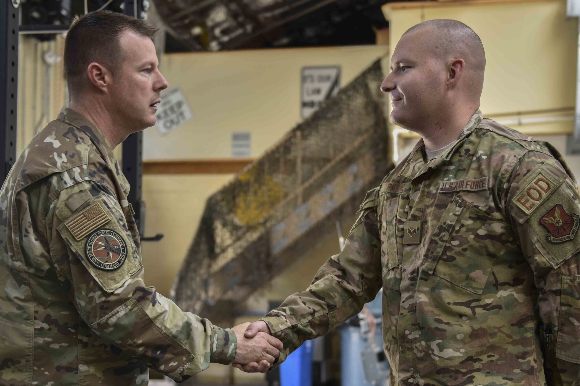 U.S. Air Force Chief Master Sgt. Charles Hoffman, Air Force Global Strike Command command chief, coins Senior Airman Norman Parks, 377th Mission Support Group Explosive Ordinance Disposal technician at Kirtland Air Force Base, June 13, 2019. Hoffman visited with Airmen across the 377th Air Base Wing to learn more about them and their mission. (U.S. Air Force photo by Airman 1st Class Austin J. Prisbrey)