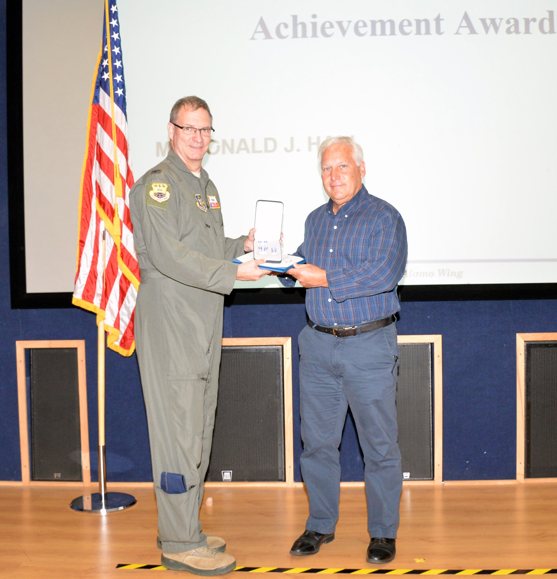 Col. Terry W. McClain, 433rd Airlift Wing commander, presents the award for civilian achievement to Don Hall, 433rd AW deputy chief of safety, June 20, 2019 at Joint Base San Antonio-Lackland, Texas.