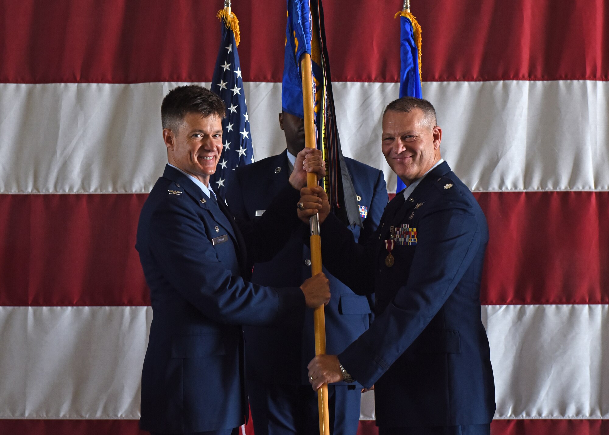 U.S. Air Force Col. Thomas Coakley, 17th Training Group commander, accepts the guidon from Lt. Col. Robert Kammerer, outgoing 316th Training Squadron commander, during the change of command ceremony at the Louis F. Garland Department of Defense Fire Academy High Bay on Goodfellow Air Force Base, Texas, June 21, 2019. The 316th TRS delivers innovative, state-of-the-art, and operationally relevant instruction to defeat current and future threats to our Nation, while developing and mentoring the next generation of warriors in cryptologic intelligence. (U.S. Air Force photo by Airman 1st Class Zachary Chapman/Released)