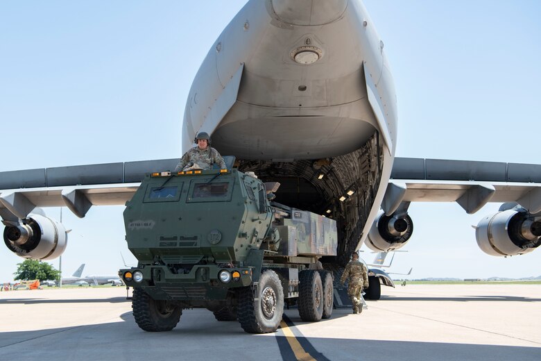 A U.S. Army High Mobility Rocket System disembarks from a C-17 Globemaster III.