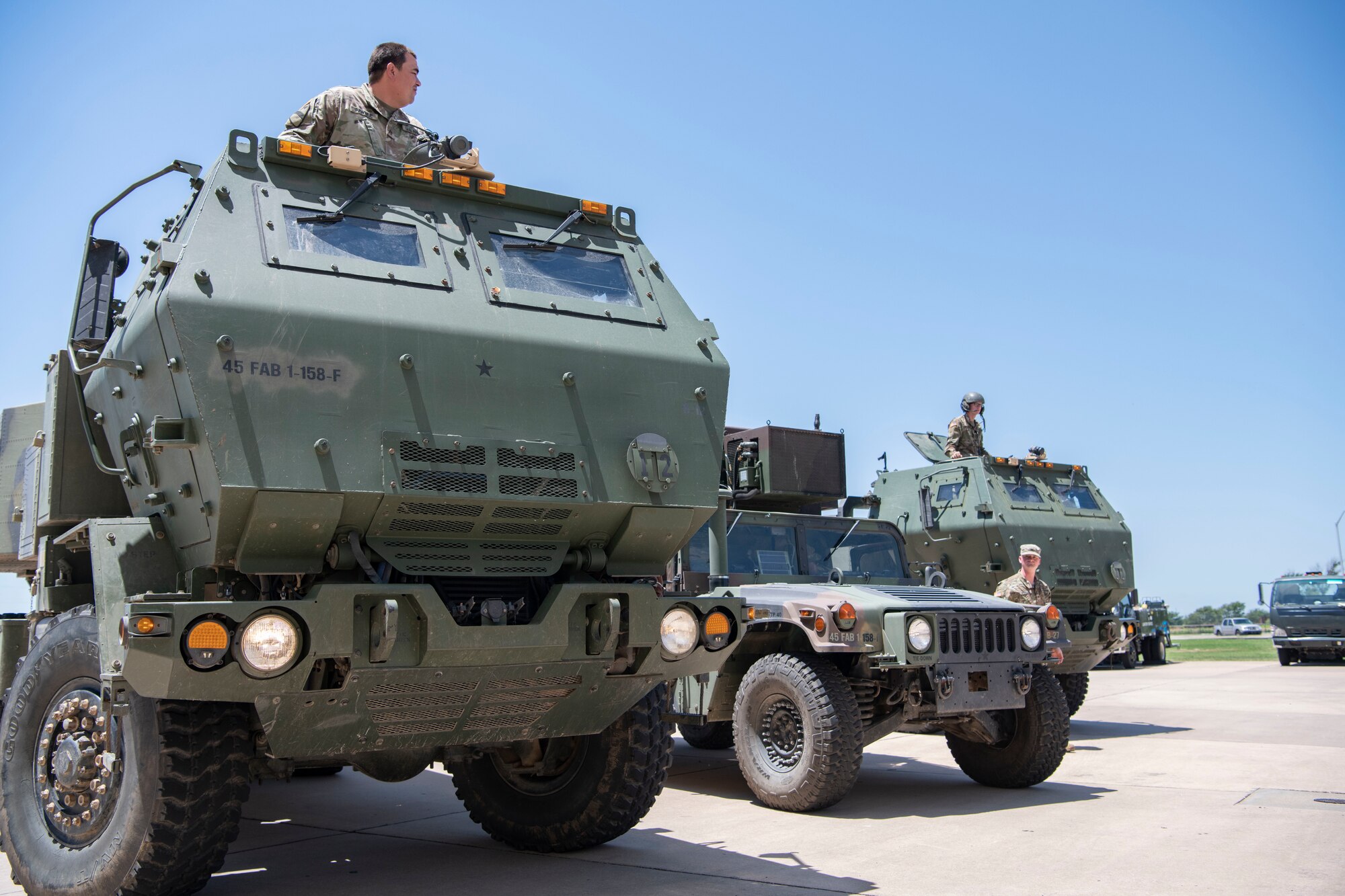 Three U.S. Army High Mobility Rocket Systems park outside of the 97th Air Operations Group.