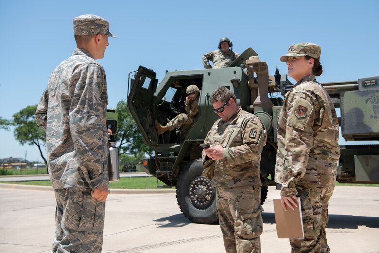 U.S. Air Force officer talks to U.S. Army Soldiers.