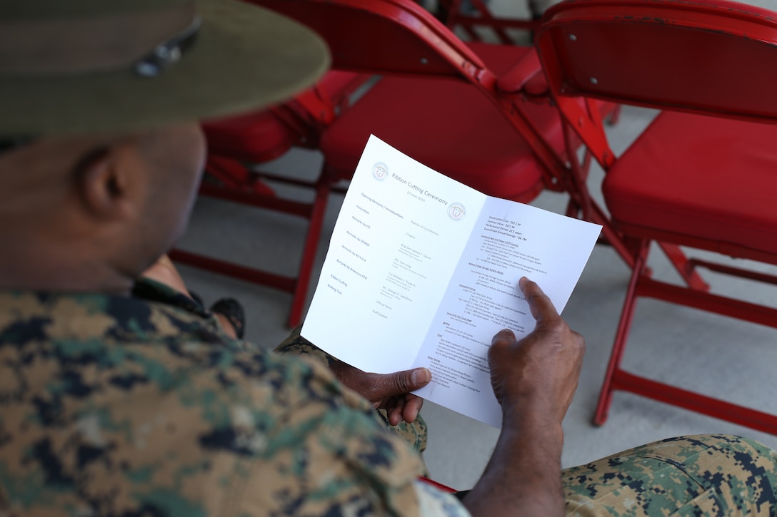 A Marine reads a pamphlet for the new power plant’s ribbon cutting ceremony on Marine Corps Recruit Depot Parris Island, S.C. June 20, 2019. This new power plant will allow Parris Island to produce energy for its facilities independently. (U.S. Marine Corps photo by Lance Cpl. Ryan Hageali)