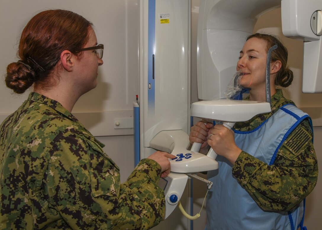 Hospital Corpsman Petty Officer 2nd Class Megan Stanford, preforms dental x-rays on a fellow Sailor June 20, 2019, at the Navy Operational Support Center on Luke Air Force Base, Ariz.