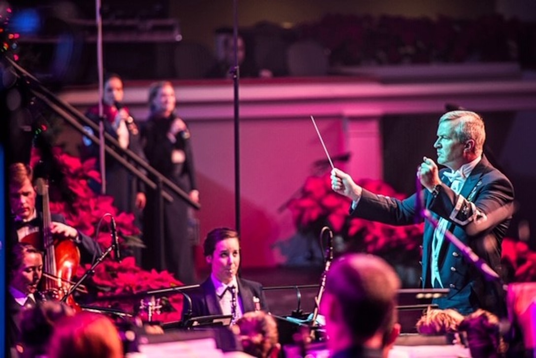 Oboist Tech. Sgt. Emily Foster watches Col. Larry Lang as he conducts The U.S. Air Force Concert Band in a performance at DAR Constitution Hall. The concert was part of the Band's "Spirit of the Season" holiday shows in Washington, D.C.